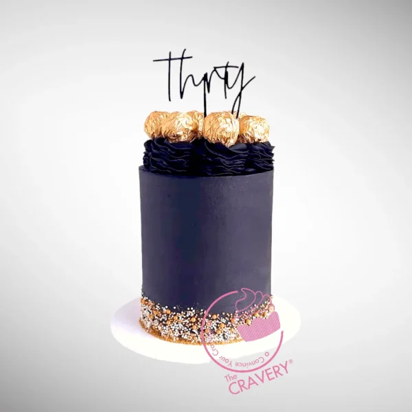 Luxury Ferrero Rocher Cake with black swirl design and Ferrero Rocher chocolates on top by The Cravery, best bakery in Birmingham.