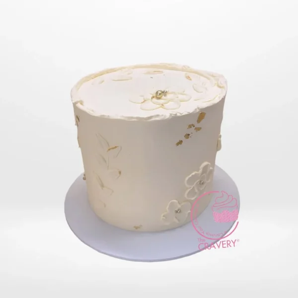 White on White Cake – A custom cake with intricate white decorations, available at our cake shop Birmingham.