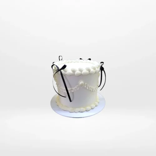 Vintage Black Bows Cake – A timeless cake with floral and lace patterns, ideal for elegant celebrations in Birmingham.