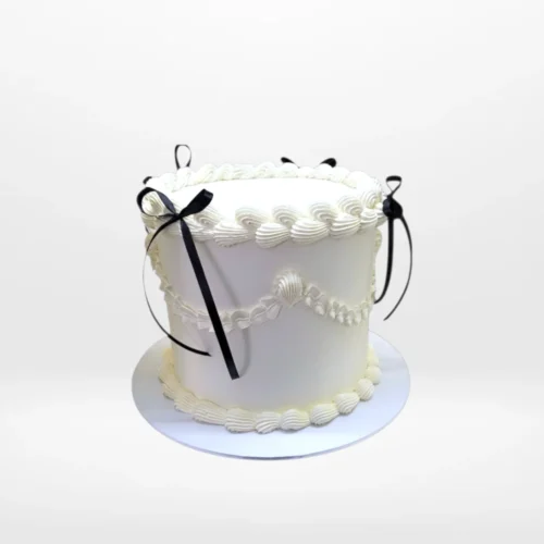 Vintage Black Bows Cake – A timeless cake with floral and lace patterns, ideal for elegant celebrations in Birmingham.