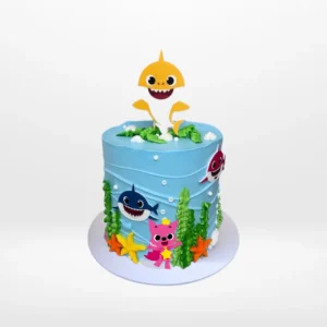 Babyshark Cake with Waves, themed blue cake with sea-inspired decorations and Baby Shark characters, from the best cake shop in Birmingham