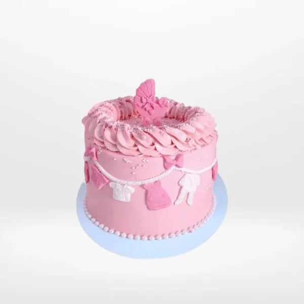 Pink Babyshower Cake decorated with clothes line theme, handcrafted by The Cravery Cake Makers in Solihull.