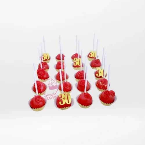 Red coloured cake pops with elegant decorative details, handcrafted by cake makers in Birmingham.