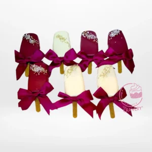 Festive Christmas cakesicles decorated with holiday designs.