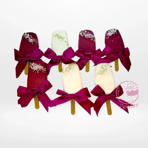 Festive mini Christmas cakesicles decorated with holiday designs.