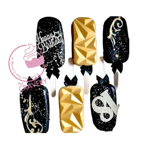 Mini cakesicles decorated with elegant crown toppers.