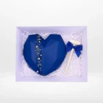 Chocolate smash heart with wooden hammer and hidden sweets inside.
