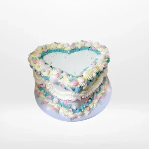Vintage heart-shaped birthday cake with elegant buttercream piping in Birmingham.