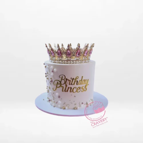 Princess tiara birthday cake with pink buttercream and royal decorations from a cake shop in Birmingham.