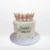Princess tiara cake with pink buttercream and royal decorations from a cake shop in Birmingham.