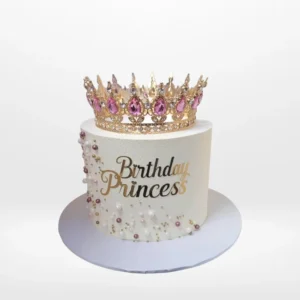 Princess tiara cake with pink buttercream and royal decorations from a cake shop in Birmingham.