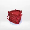 Red heart-shaped cake with smooth buttercream and personalised message.