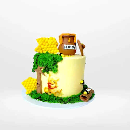 Winnie the Pooh birthday cake with edible sugarpaste decorations and edible prints from Cake Shop Birmingham.